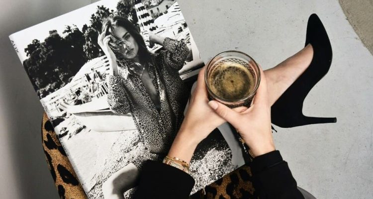 girl holding a magazine and coffee