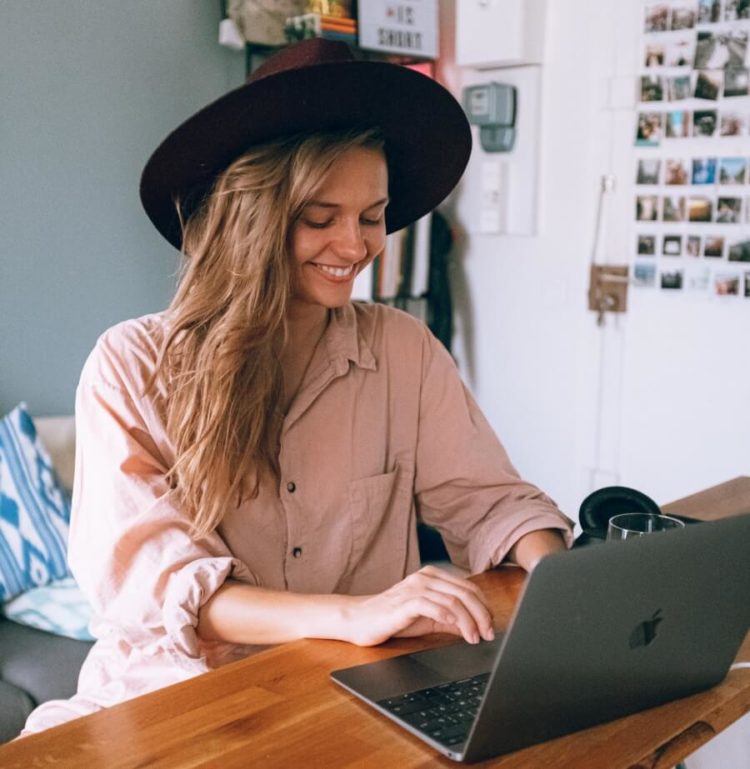 Smiling Woman Using Laptop