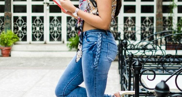 Stylish woman in high heeled shoes reading book