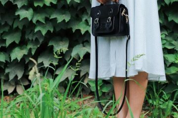 Woman Holding Black Leather Bag Beside Bush